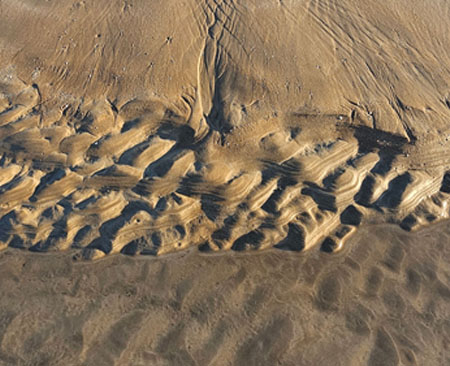 Ripples, textures and water on the beach at Casuarina, Darwin.