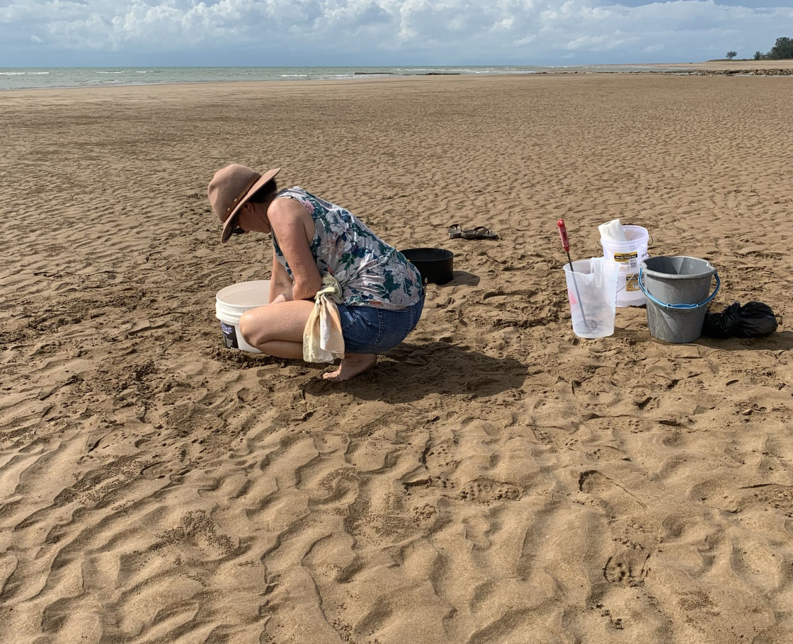 The artist Maria Kraatz preparing to pour plaster on ripples at Casuarina Beach in Darwin.