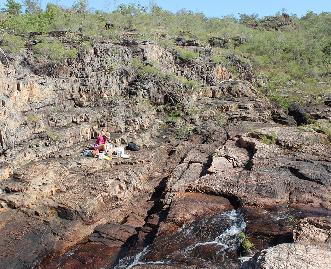 The artist working in a rocky gorge in the Top End of the Northern Territory.