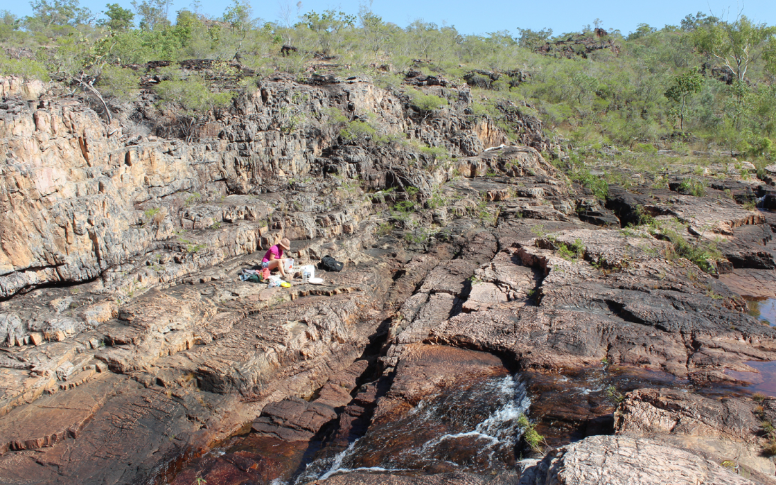 The artist Maria Kraatz working in a rocky gorge in northern Australia.